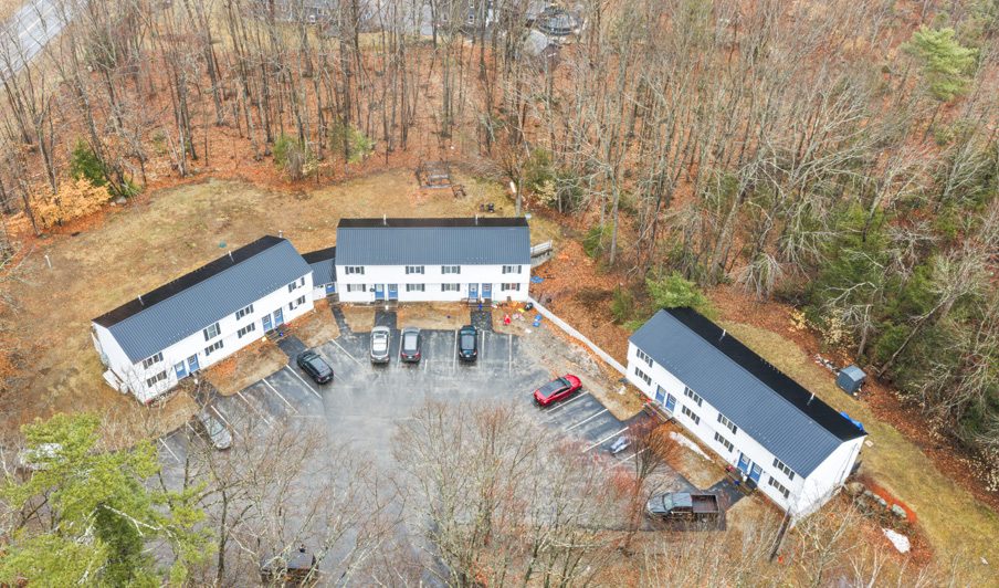 Aerial view of Hollis apartment buildings surrounded by woods