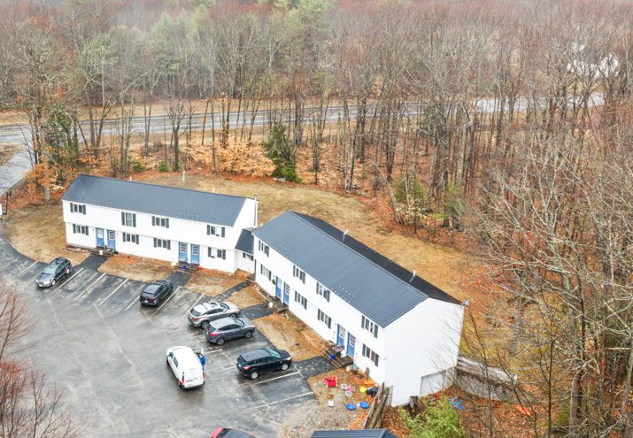 Aerial view of two apartment buildings and parking