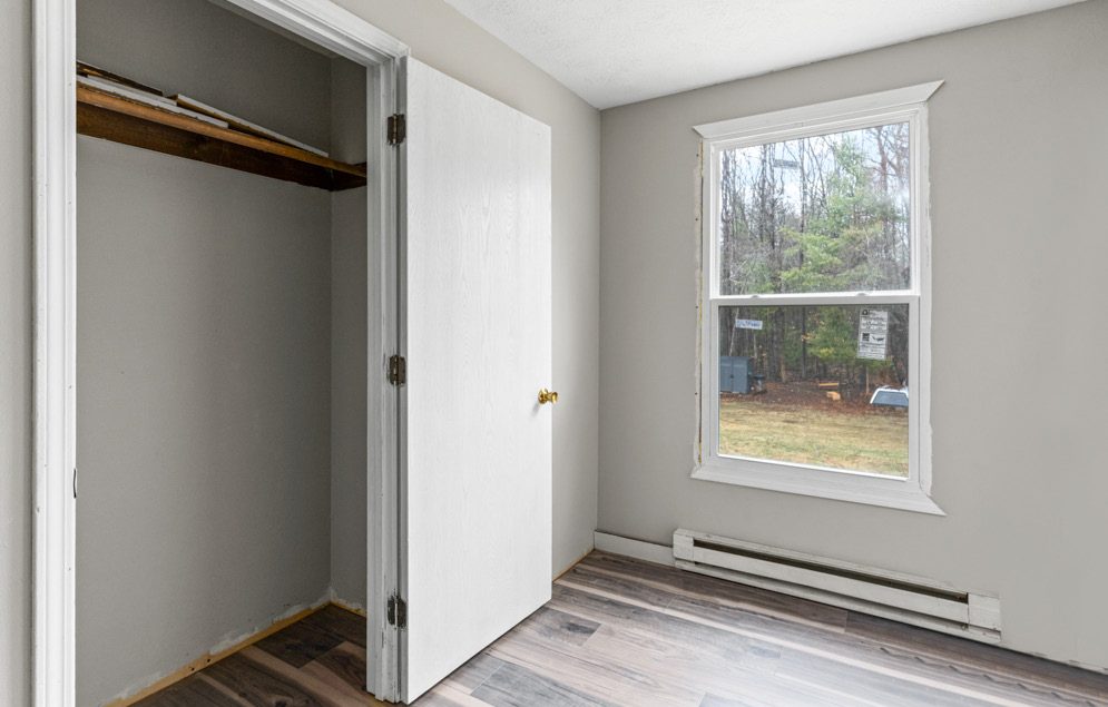 Bedroom with closet and window