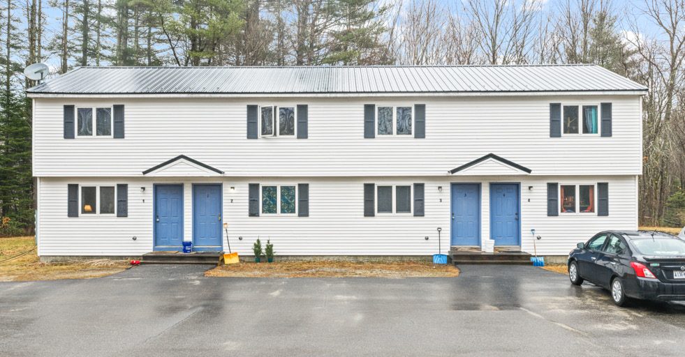 Two-story apartment building with blue doors