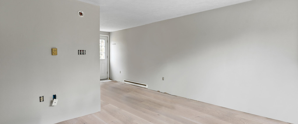 Representative interior: open living area with fresh paint and wood-look flooring