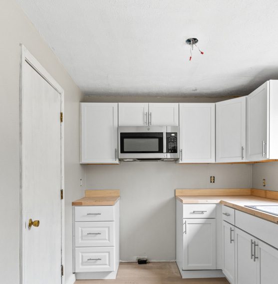 Kitchen with white cabinets and microwave